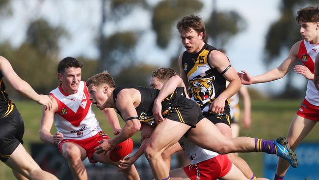 Tigers midfielder Eddie Cole is tackled by Clarence’s Jack Preshaw in the round 21 loss. Picture: Nikki Davis-Jones