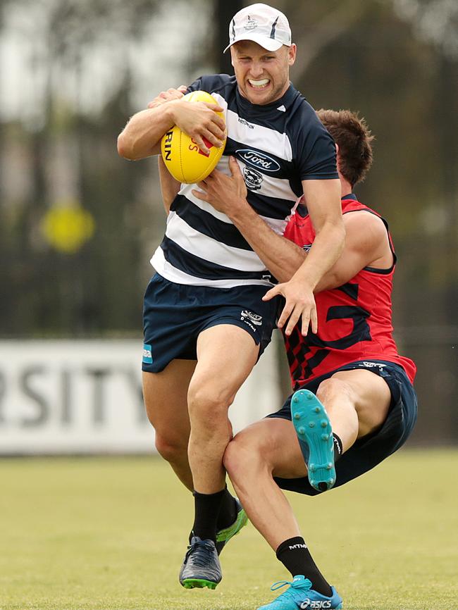 Gary Ablett smashes past Dan Menzel at Cats training. Picture: Alison Wynd