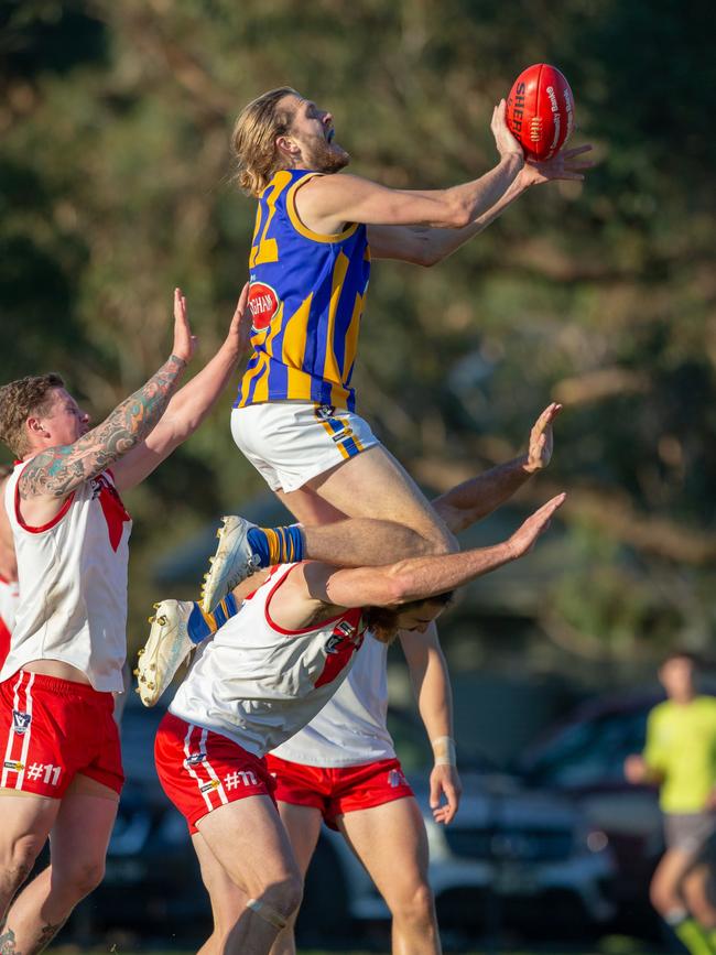 Somerville’s Luke Rowe gets up high against Karingal. Picture: Gary Bradshaw