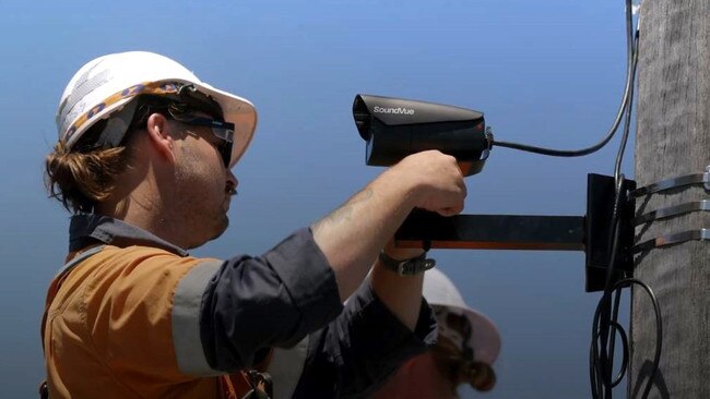 Workers install the high-technology cameras on Tuesday.