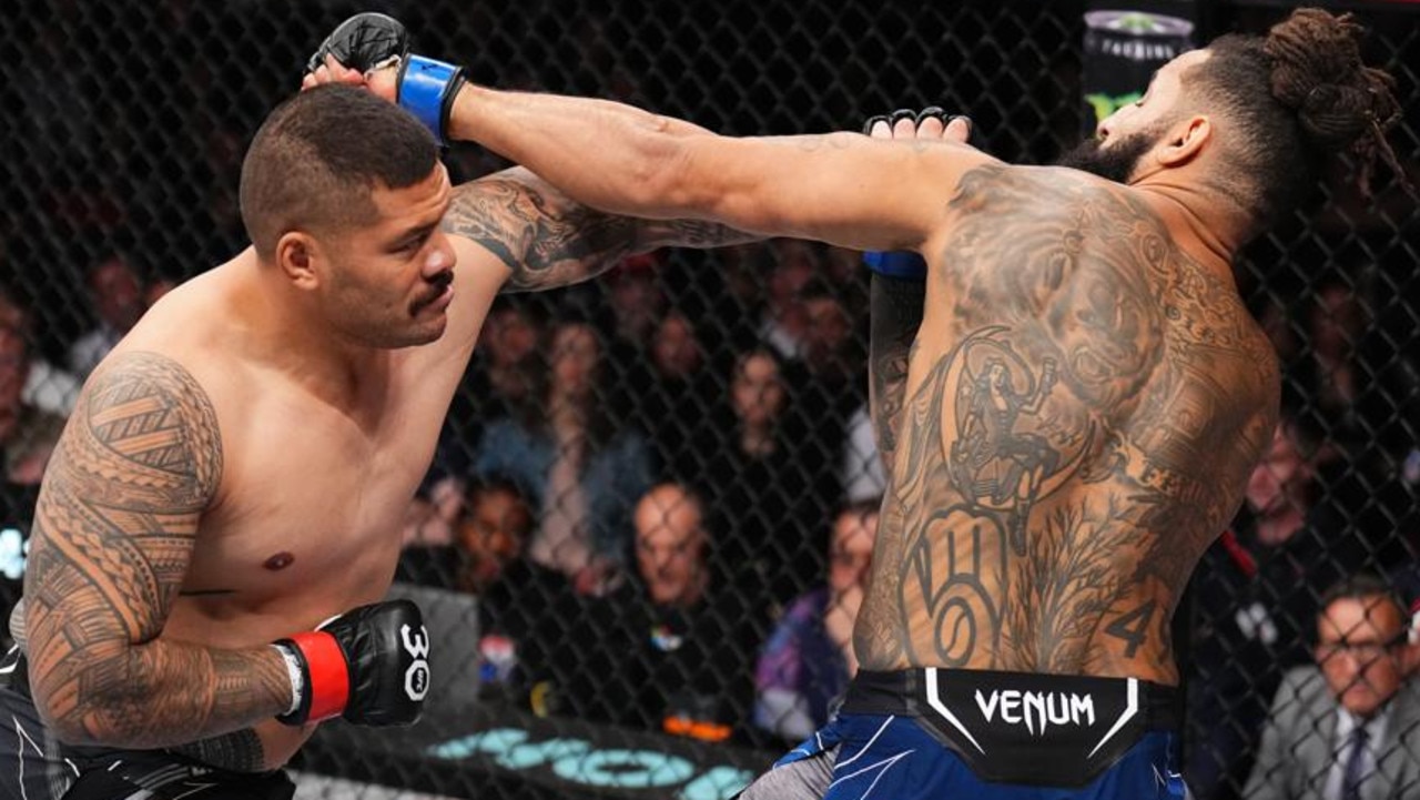 SYDNEY, AUSTRALIA - SEPTEMBER 10: (L-R) Justin Tafa of New Zealand punches Austen Lane in a heavyweight fight during the UFC 293 event at Qudos Bank Arena on September 10, 2023 in Sydney, Australia. (Photo by Chris Unger/Zuffa LLC via Getty Images)