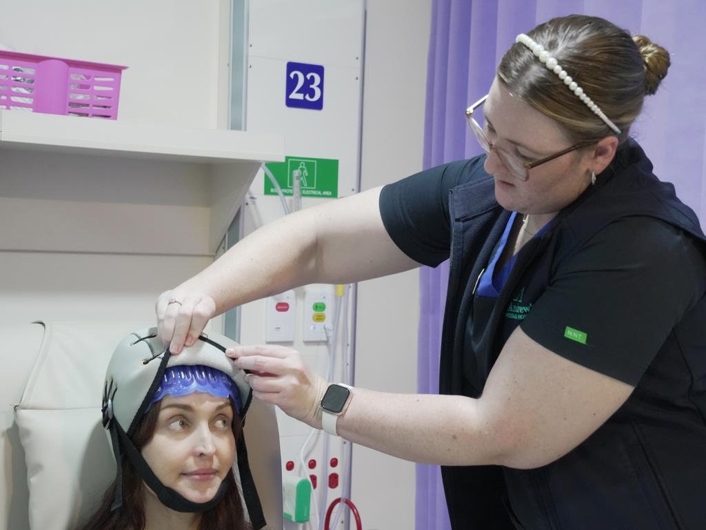 St Andrew’s Hospital Toowoomba nurses Gabrielle Priestly and Sigrid Burton trying out the new Paxman Scalp Cooling cap.