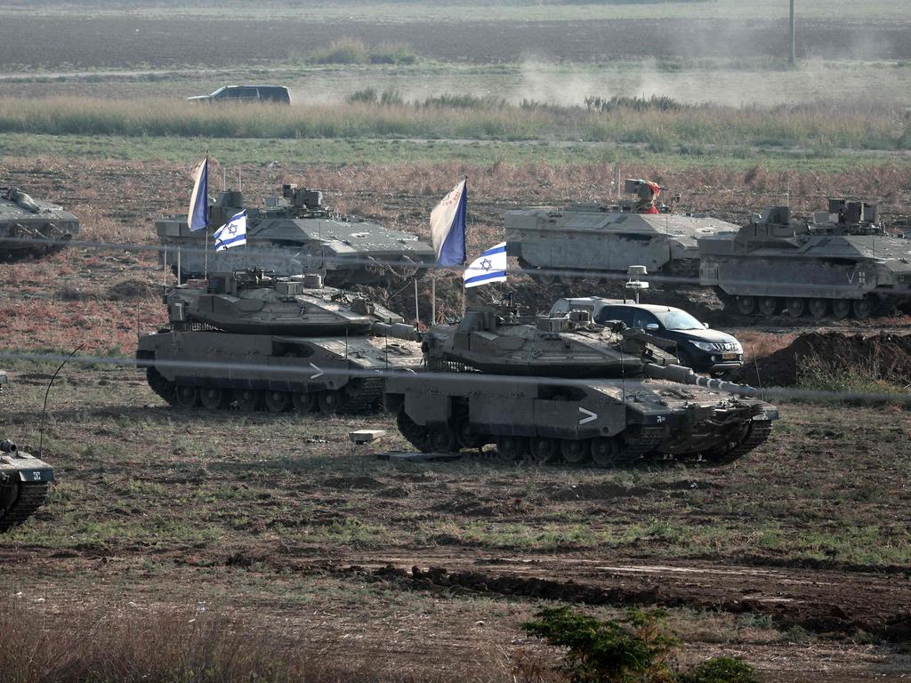 Israeli troops in tanks and other armoured vehicles amass in a field near the southern Israeli city of Ashkelon.