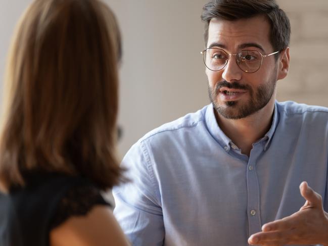 Caucasian male applicant answers on questions to HR female manager during job interview in office. Meeting process, negotiations communications between business parties, solutions and opinion concept