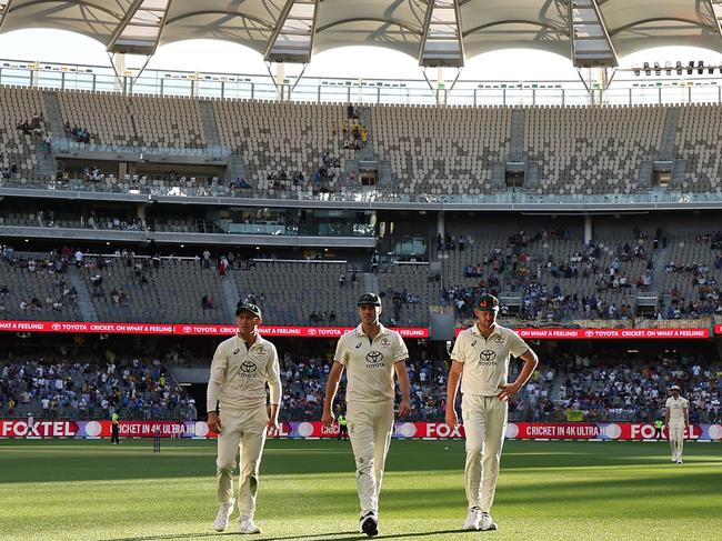 PERTH, AUSTRALIA - NOVEMBER 23: Marnus Labuschagne, Pat Cummins and Josh Hazlewood of Australia walk off the field at the end of play on day two of the First Test match in the series between Australia and India at Perth Stadium on November 23, 2024 in Perth, Australia. (Photo by Robert Cianflone/Getty Images)