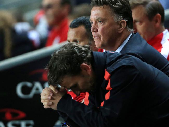 Manchester United Manager Louis van Gaal, centre rear, shows his dejection after their defeat by MK Dons in their League Cup Second Round match at Stadium:mk, Milton Keynes, England, Tuesday Aug. 26, 2014. MK Dons defeated Manchester United 4-0. (AP Photo/PA, Nick Potts) UNITED KINGDOM OUT NO SALES NO ARCHIVE