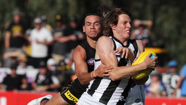 Nathan Murphy is wrapped up by Daniel Rioli. Picture: Michael Klein.