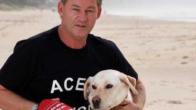 Gold Coast dog owner Phillip Deed with his dog Ace is pushing for more flexible hours to allow pets on beaches. Photo: Steve Holland