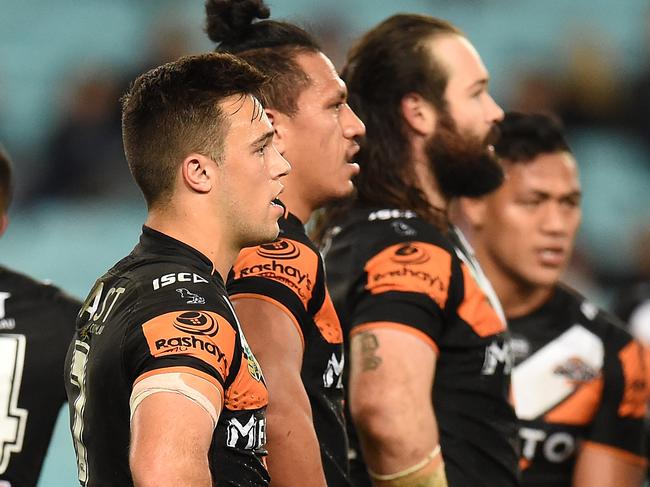 A dejected Tigers during their loss to the Roosters during the round 20 NRL match between the Wests Tigers and the Sydney Roosters at ANZ Stadium in Sydney, Friday, July 24, 2015. (AAP Image/Dean Lewins) NO ARCHIVING, EDITORIAL USE ONLY