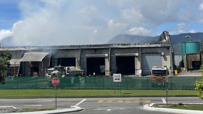 The fire continued to smoulder on Friday morning with hoses still wetting down the burning materials inside the facility. Photo: Dylan Nicholson