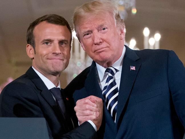 French President Emmanuel Macron embraces American President Donald Trump embracing at the conclusion of a news conference at the White House. Picture: Andrew Harnik