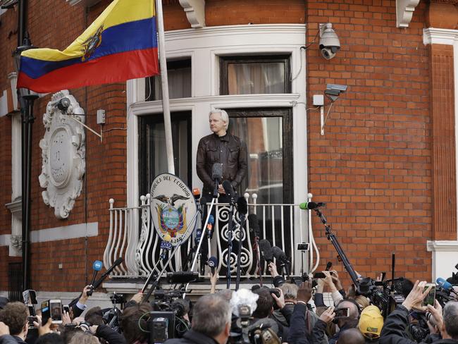 WikiLeaks founder Julian Assange looks out from the balcony of the Ecuadorean embassy. Picture: AP