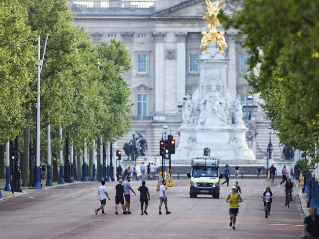 People run, walk and cycle along the Mall in central London during the coronavirus pandemic. Picture: AP Photo/Vudi Xhymshiti