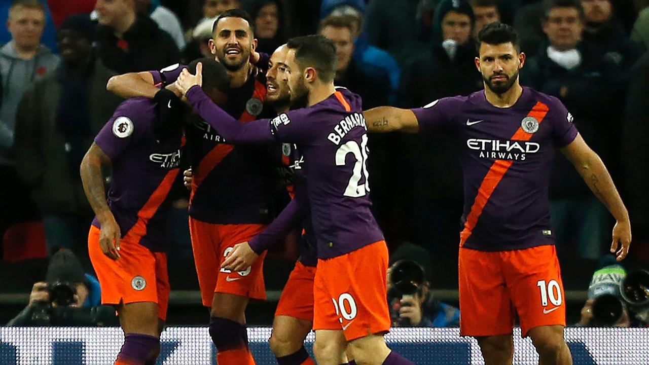 Riyad Mahrez (2L) celebrates. (Photo by Ian KINGTON / IKIMAGES / AFP)