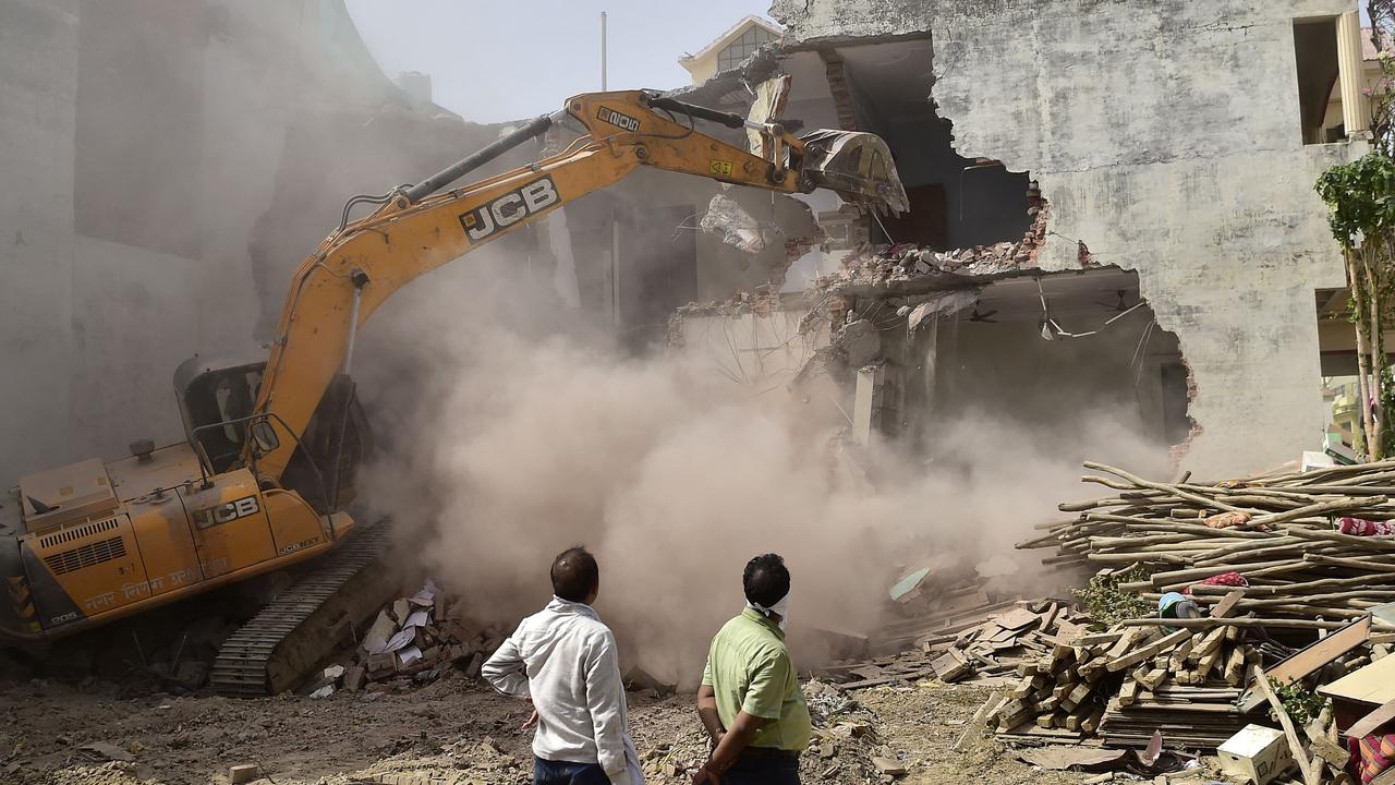 A bulldozer is being used to demolish the residence of Javed Ahmed, a local leader who was allegedly involved in the recent protests. Picture: Sanjay Kanojia/AFP