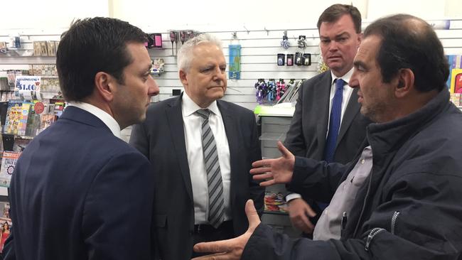 Young St Newsagency owner Vasilis Aroutzidis, right, talks about closing his business with Victorian Opposition leader Matthew Guy, left, and Liberal MPs Neale Burgess and Edward O'Donohue.