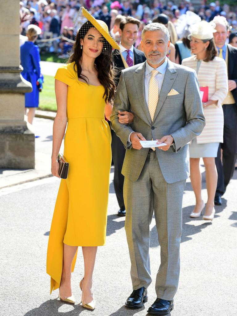 Amal and George (above at royal wedding) are to be godparents. Picture: Ian West.