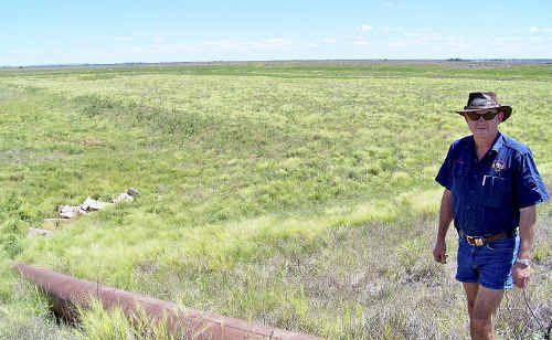 Graham Clapham shows an overland irrigation dam on his Cecil Plains property, which he says has been empty since 2003.