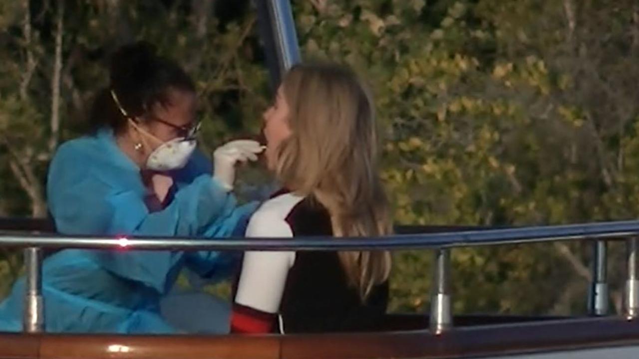 Health worker tests Cheryl Simonds for COVID-19 aboard the luxury yacht, Lady Pamela on Tuesday. Picture: Channel 9/ACA