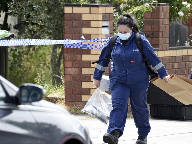 Police remove evidence from the scene. Picture: Andrew Henshaw