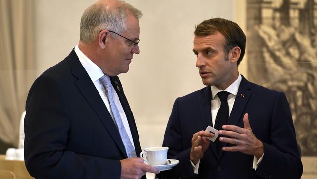 Australian Prime Minister Scott Morrison and French President Emmanuel Macron talk before the G20 leaders make a short visit to the Fontana di Trevi in Rome on October 31, 2021. Picture: Adam Taylor