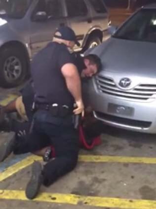 An officer reaches for his gun before the fatal shooting of Alton Sterling.