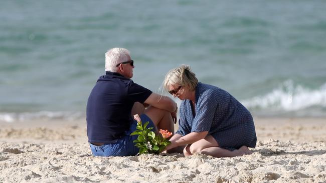 Flowers are laid in the sand after the sad death of Alex Pullin. Picture: Nigel Hallett