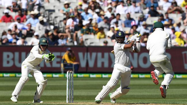 India’s Cheteshwar Pujara shows a little flair during a typically resolute innings on the docile MCG wicket yesterday. Pictures: AAP