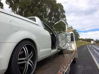 A ute being loaded onto a tow truck. Picture: Jonno Colfs