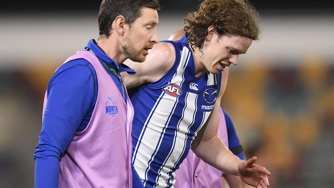 BRISBANE, AUSTRALIA - AUGUST 05: Ben Brown of the Kangaroos walks off the field injured during the round 10 AFL match between the Geelong Cats and the North Melbourne Kangaroos at The Gabba on August 05, 2020 in Brisbane, Australia. (Photo by Albert Perez/AFL Media/via Getty Images)