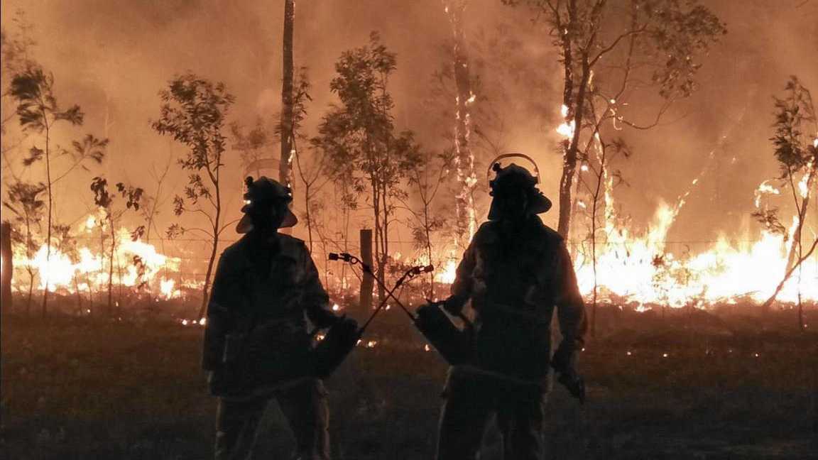 ON THE FRONT LINE: Nicole Moyle captured this photo of two Firefighters on the frontline at Deepwater. Picture: Nicole Moyle