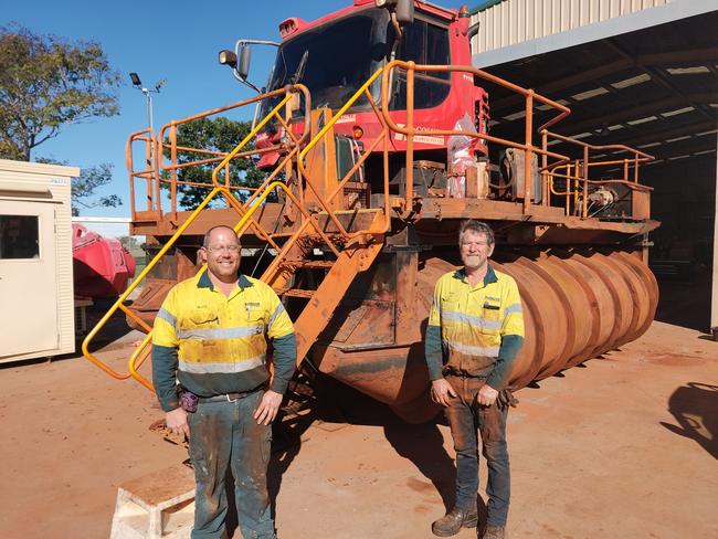 McCoskers Contractors employees with the $1 million Gladstone designed engineered and constructed bouyant scrolling machine used to extend mining tailings dam walls. Picture :Rodney Stevens