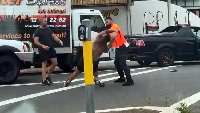 The man in the high-vis top grounds the man with no shirt on. Picture: Twitter