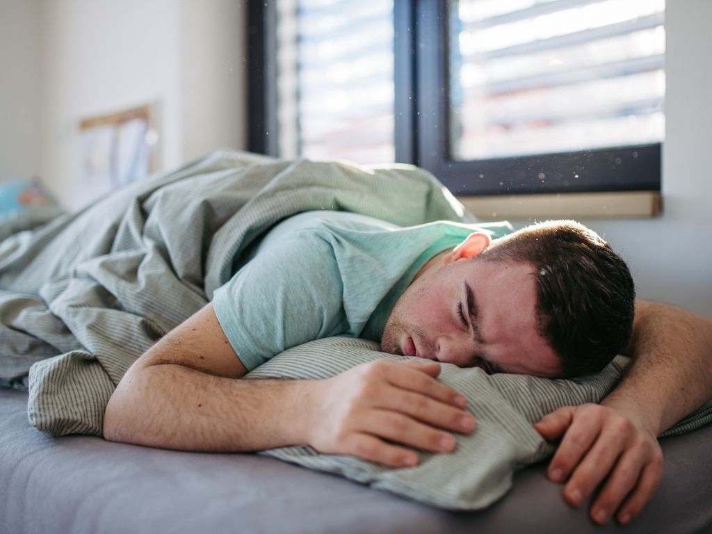 While it's not the ideal position, stomach sleepers can still comfortably sleep on their belly with a couple of adjustments. Picture: iStock/Halfpoint.