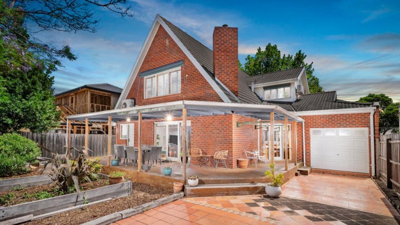 The backyard with planter boxes and a large veranda.