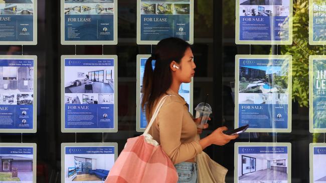 A pedestrian walks past a real estate agency in Sydney’s central business district.