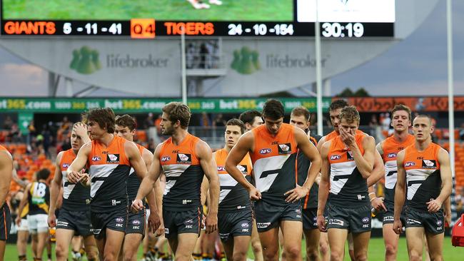 Dejected Giants leave the field after a 113-point loss to Richmond. Picture: Phil Hillyard