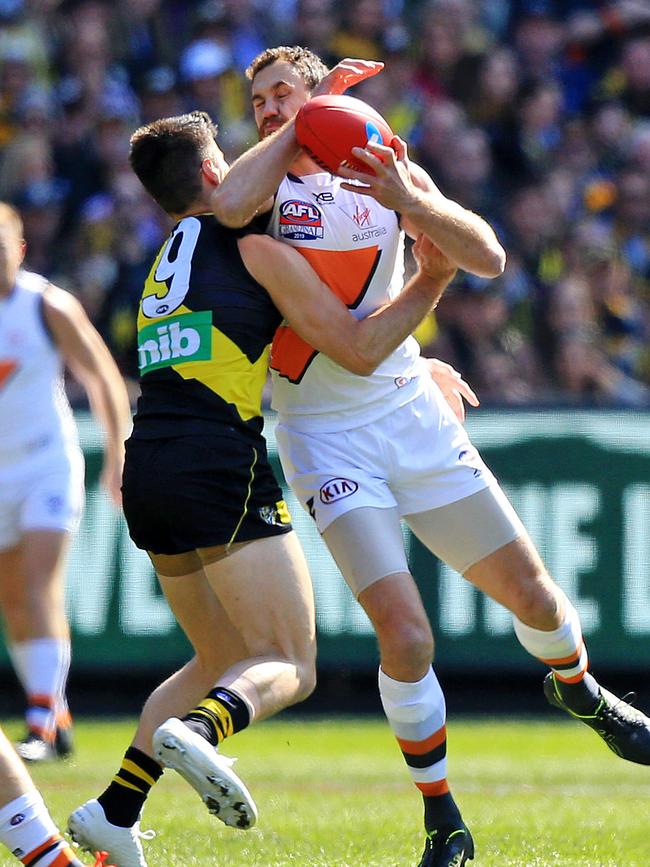 Trent Cotchin of the Tigers contests with Shane Mumford of the Giants. Picture: Mark Stewart