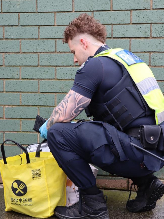 Police search bags during a blitz on drug dealing in Springvale. Picture: Victoria Police