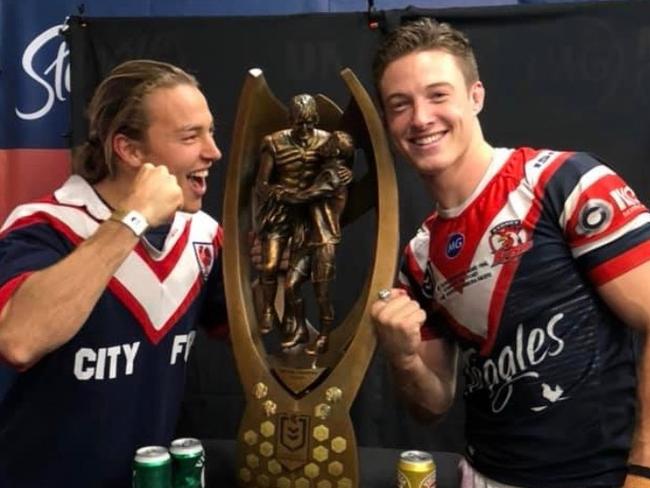 Sam Verrills and brother Billy with the NRL premiership trophy.