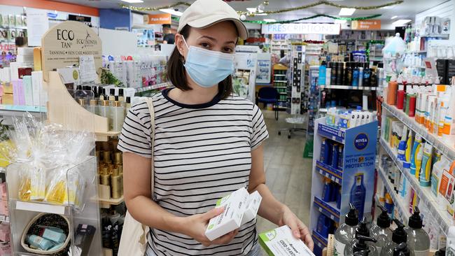 Elly Spiro buys three packs of rapid antigen tests at Bondi Pharmacy before travelling to Brisbane. Picture: Toby Zerna