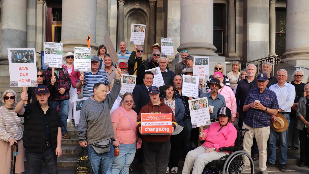 Abbeyfield House residents and supporters hand over a petition to MP Frank Pangallo on the parliament steps to protest the sale of their home. Picture: Supplied