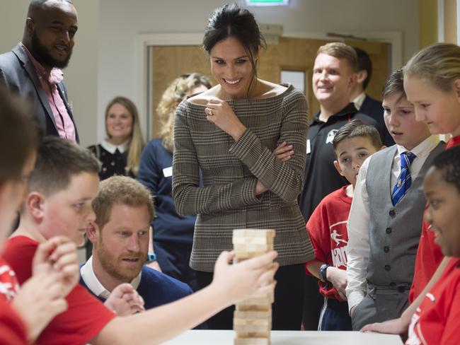 Prince Harry and his fiancée Meghan Markle watch a game of Jenga during their visit to Star Hub on January 18, 2018 in Cardiff, Wales. Picture: Getty