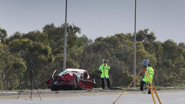 Major Crash Investigators examine the red Toyota Prius. Picture: Dean Martin