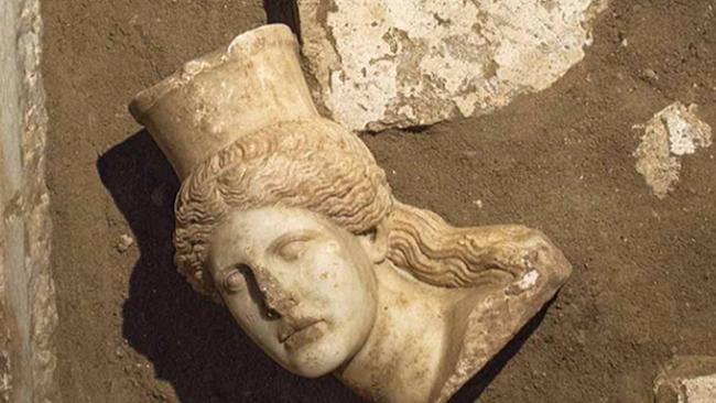 This picture provided by Greece's Culture Ministry, Oct. 20, 2014, shows the broken-off head of a marble sphinx, one of a pair that decorated the entrance of a large 4th century B.C. tomb under excavation at Amphipolis in northern Greece. Bones from a skeleton found in the tomb's innermost chamber could help solve the riddle of who was buried in opulent splendor there. A Culture Ministry statement on Wednesday, Nov. 12, 2014, said the skeleton was strewn in and around a rectangular stone-lined cist, under the floor of the cavernous, vaulted structure that is 8 metres (26 feet) tall. (AP Photo/Greek Culture Ministry)