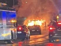 Car fire causing traffic delays along Musgrave Rd in Red Hill on Monday night. Photo: Laura Hannah