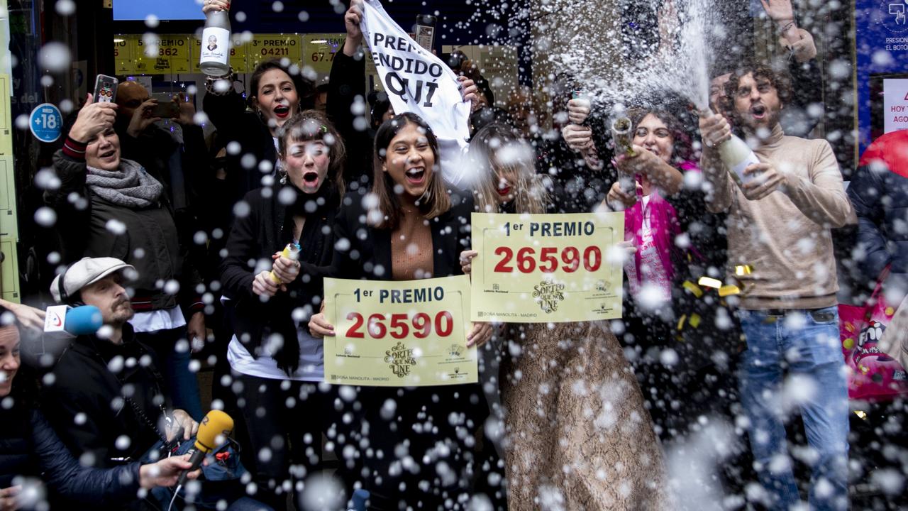 Lottery shop owners and employees celebrate after selling the winning ticket number of Spain's Christmas lottery named 'El Gordo' (The Fat One). Picture: Pablo Blazquez Dominguez/Getty Images)
