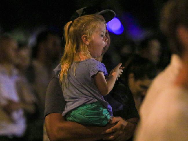 Paige Pike, held by father Adrian, yawning at the Anzac Day Dawn Service at Darwin Cenotaph Picture: Glenn Campbell