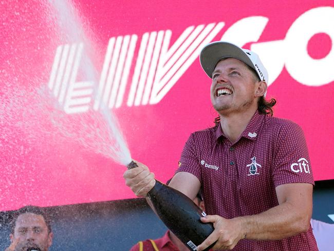 Cameron Smith of Australia celebrates on the podium after winning the LIV Golf-Bedminster 2023 at the Trump National in Bedminster, New Jersey on August 13, 2023. Australia's Cameron Smith, last year's British Open champion, fired a three-under-par 68 on Sunday for a blowout victory at the LIV Golf League event at Trump National Bedminster. The 29-year-old from Brisbane finished 54 holes at the New Jersey layout on 12-under 201 with India's Anirban Lahiri a distant second, seven strokes adrift. (Photo by TIMOTHY A. CLARY / AFP)