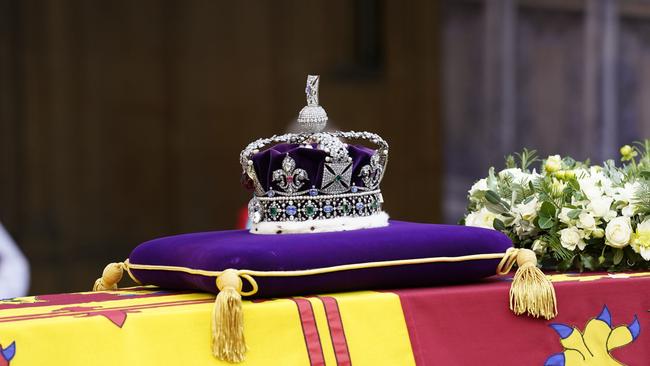 The Queen’s coffin, adorned with a Royal Standard and the Imperial State Crown, arrives at Westminster Hall where it will lie in state. Picture; Getty Images.